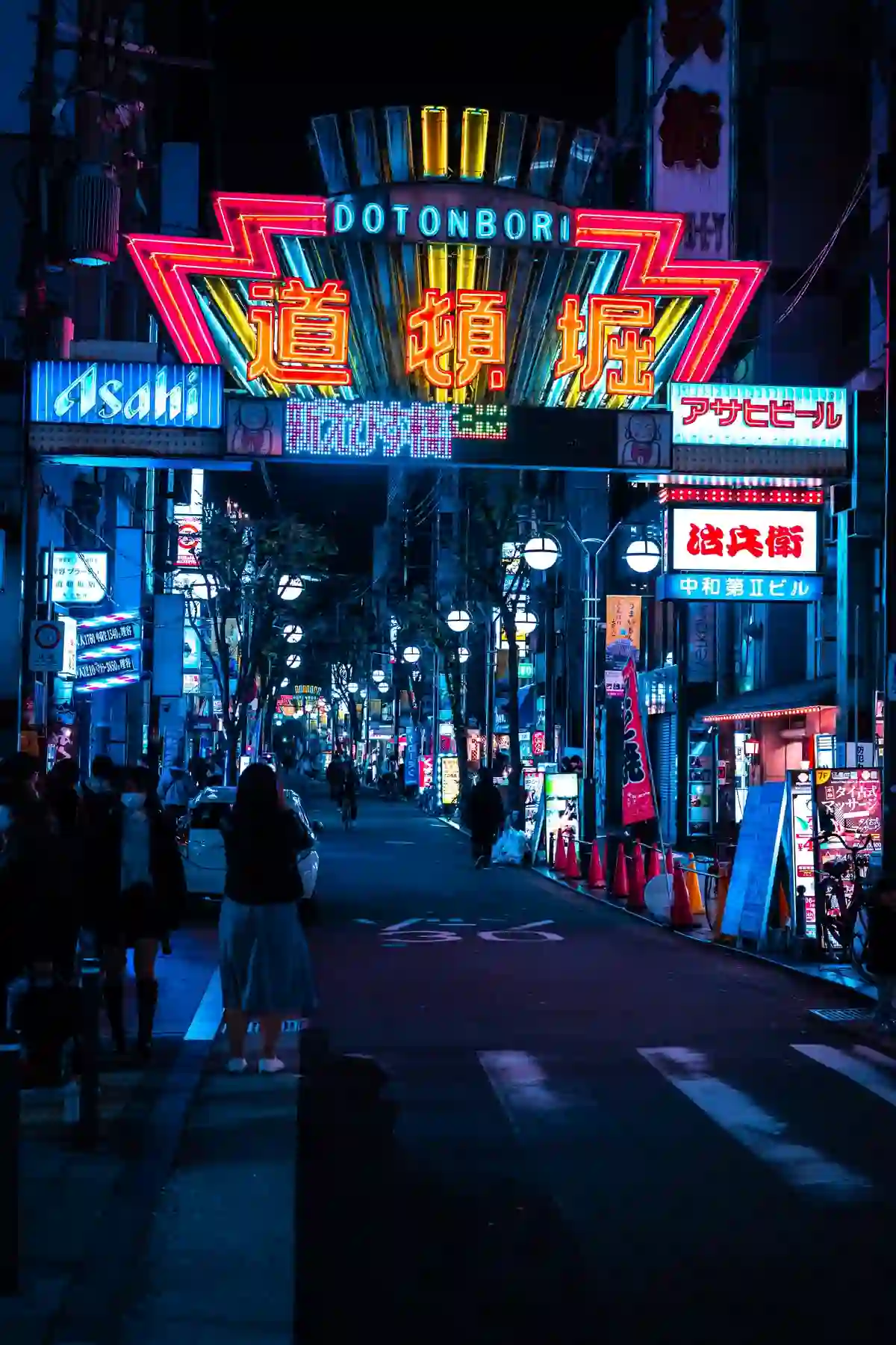 A neon-lit street at night in Osaka's Dotonbori district